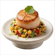 Seared Nippon scallop on charred corn and lime relish with a nasturtium leaf, on a footed plate — iDoCatering canapé