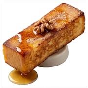 Thick caramelised French toast stick topped with walnuts and maple syrup pooling beneath — iDoCatering buffet