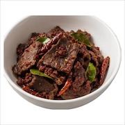 Kambing dendeng, sliced mutton fried with dried chillies and kaffir lime leaves in a white bowl — iDoCatering buffet