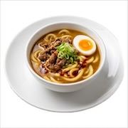 Curry udon in a rich broth with a halved soft egg and spring onion, in a white bowl — iDoCatering buffet