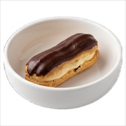 Chocolate-glazed eclair with cream filling in a white bowl — iDoCatering buffet