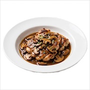 Stewed mushroom chicken chop under a rich mushroom gravy with parsley, in a white bowl — iDoCatering buffet