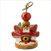 Beef salami, olive, cheese and cherry tomato stacked on a toasted bread round with a skewer — iDoCatering canapé
