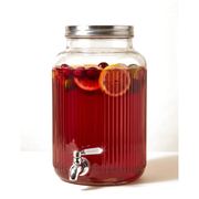 Deep red fruit punch with orange slices, lemon and cranberries in a glass drinks dispenser with a tap — iDoCatering