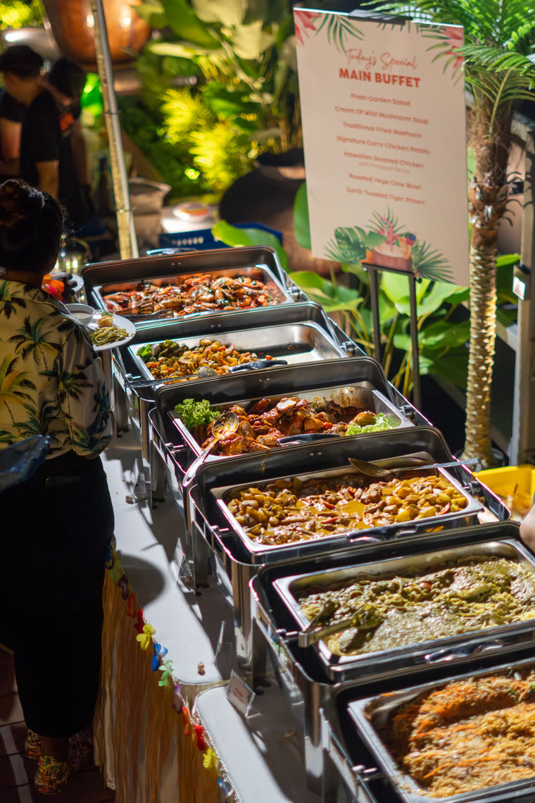 Buffet line of chafing dishes with the day's menu board at a garden party — iDoCatering buffet catering