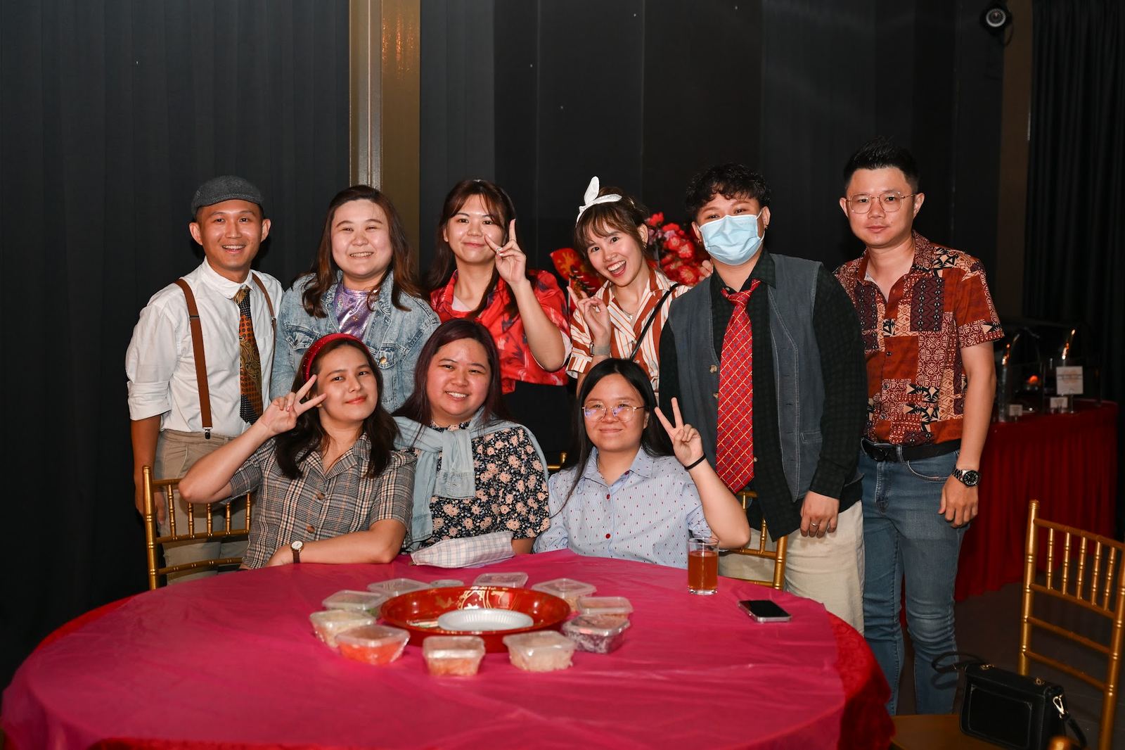 Nine colleagues around a round banquet table with a pink cloth at the Hometaste annual dinner 2025