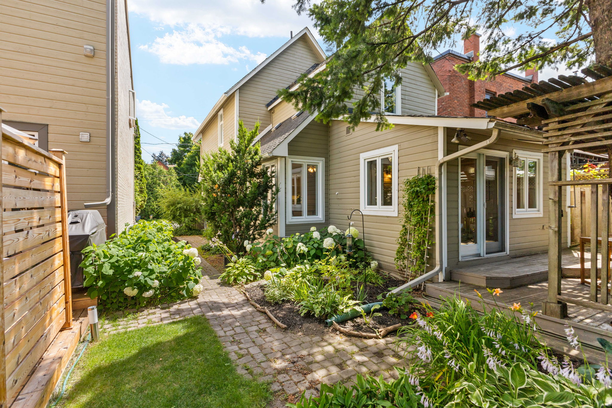 A planted side garden and stone path beside an Ottawa home