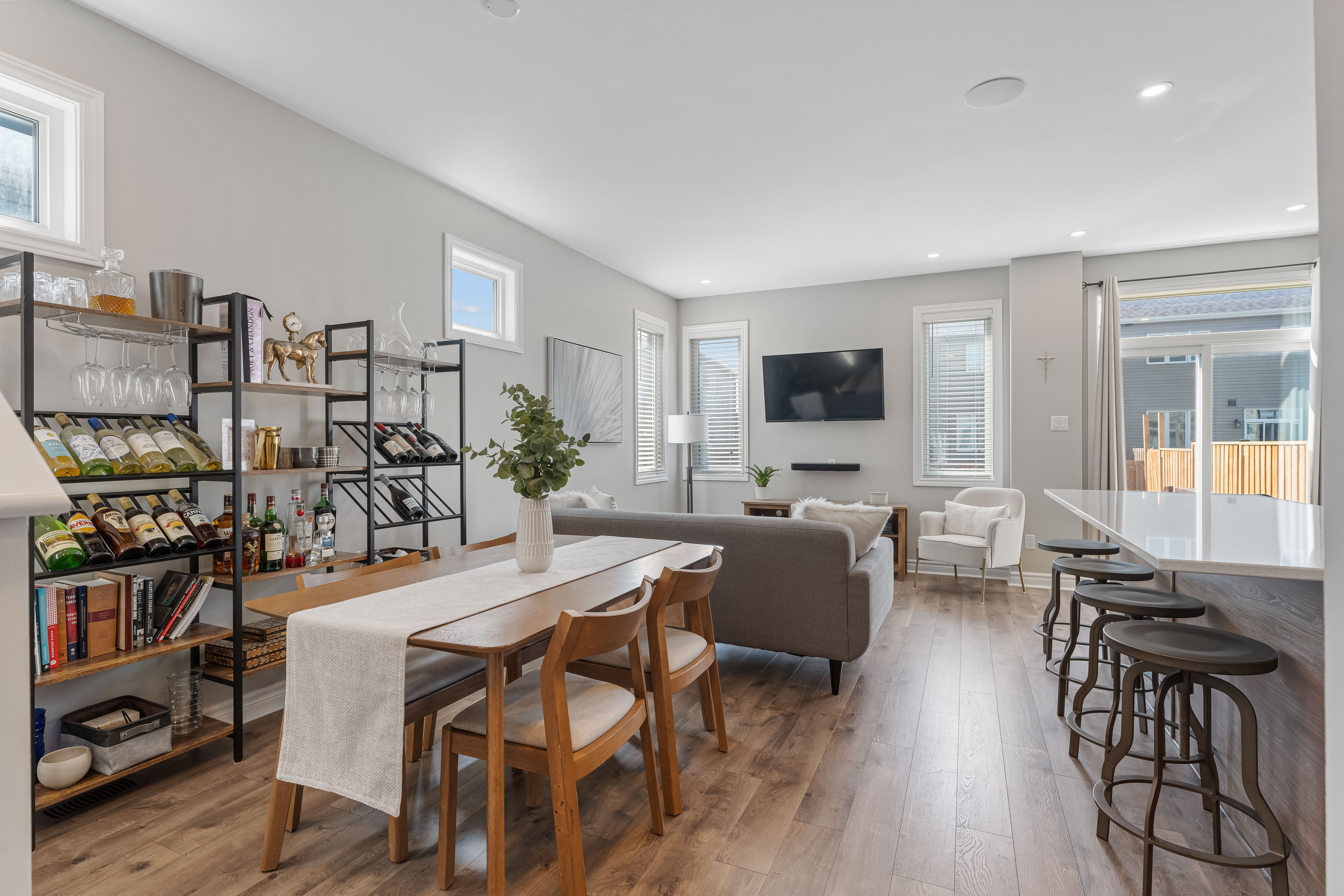 An open dining and living area with shelving along one wall