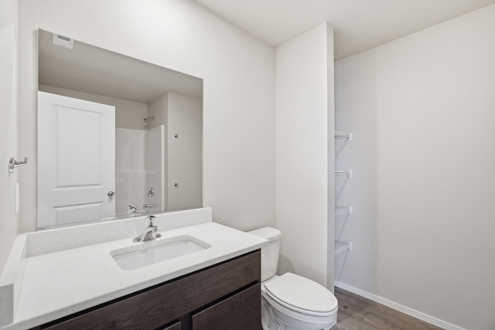 The second full bathroom in a Phoenix plan home, with a tub and shower and a single vanity.