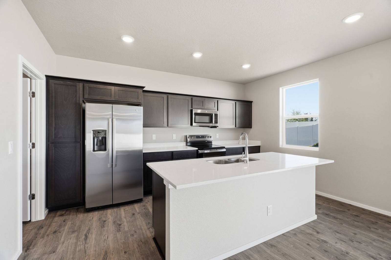 The primary bathroom in a Phoenix plan home, with a double vanity and a walk-in shower.