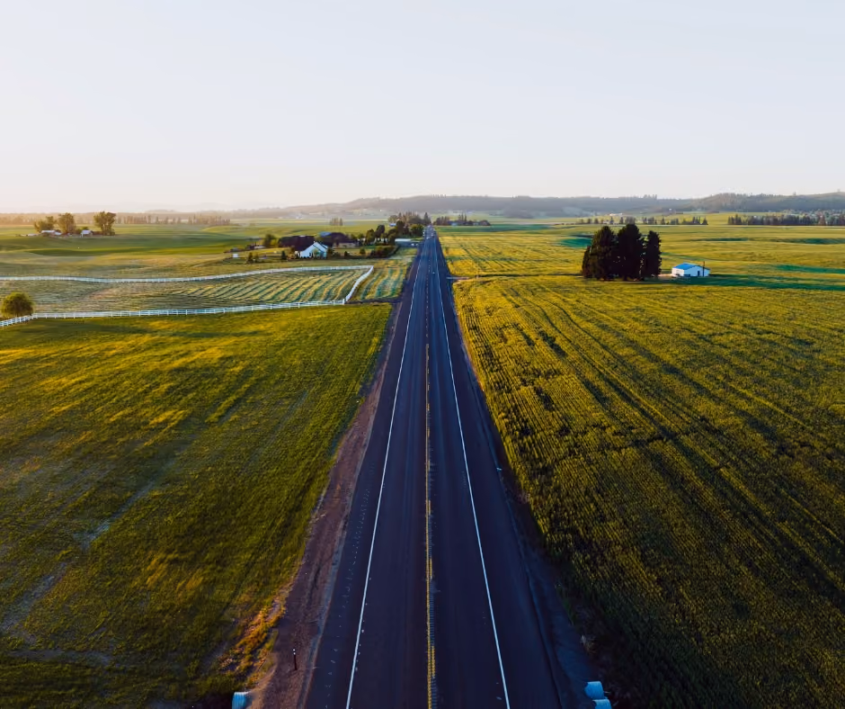 Two-lane highway running north through open farmland outside Deer Park, Washington.