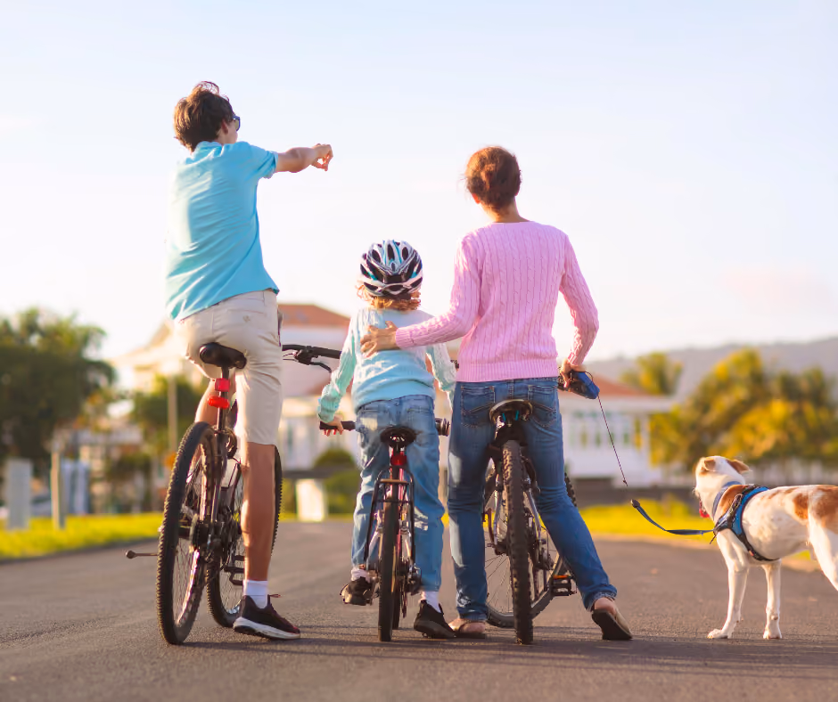 Riding bicycles on a quiet neighborhood street on a summer afternoon.