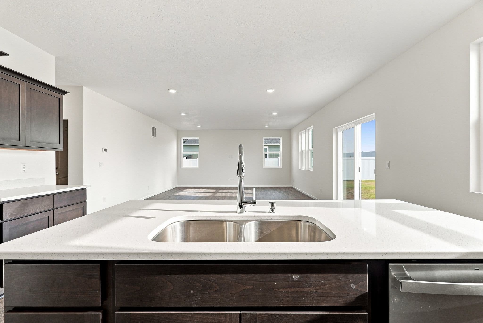 A Clearwater plan kitchen island looking out across the dining and living area.