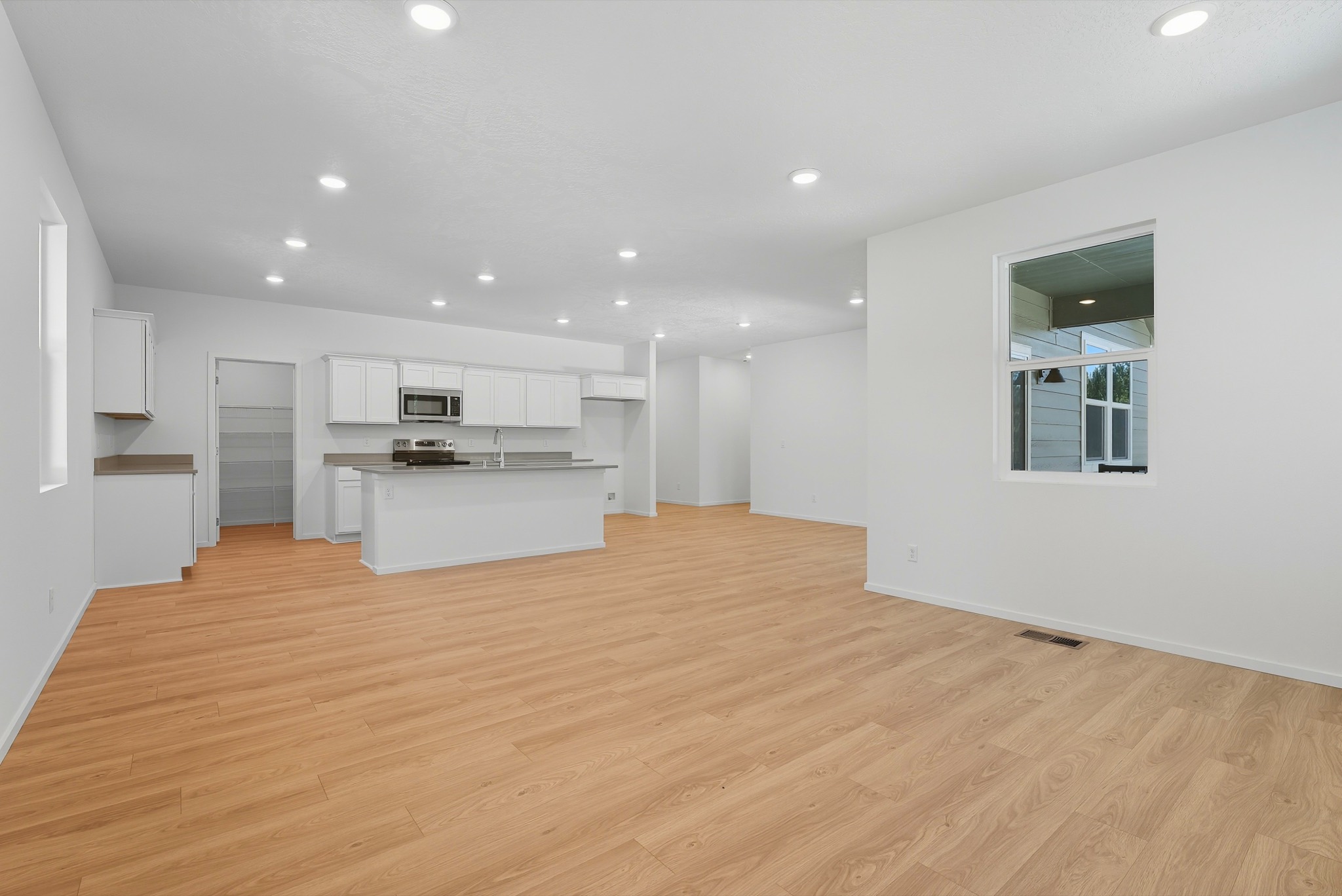 The Clark Fork plan: the great room open to the kitchen, with a pass-through window to the covered porch.