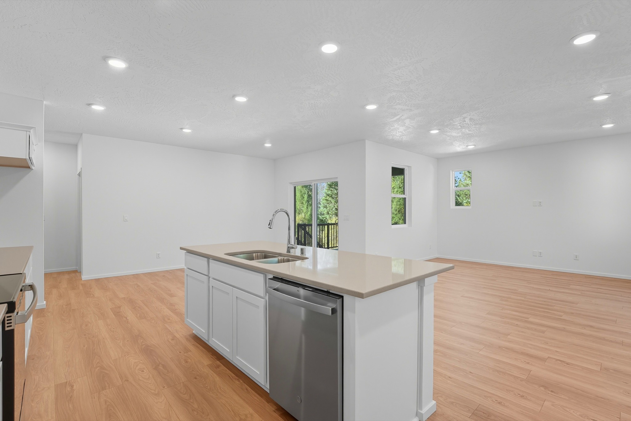 The Clark Fork plan: the kitchen island with an undermount double sink and dishwasher, open to the great room.