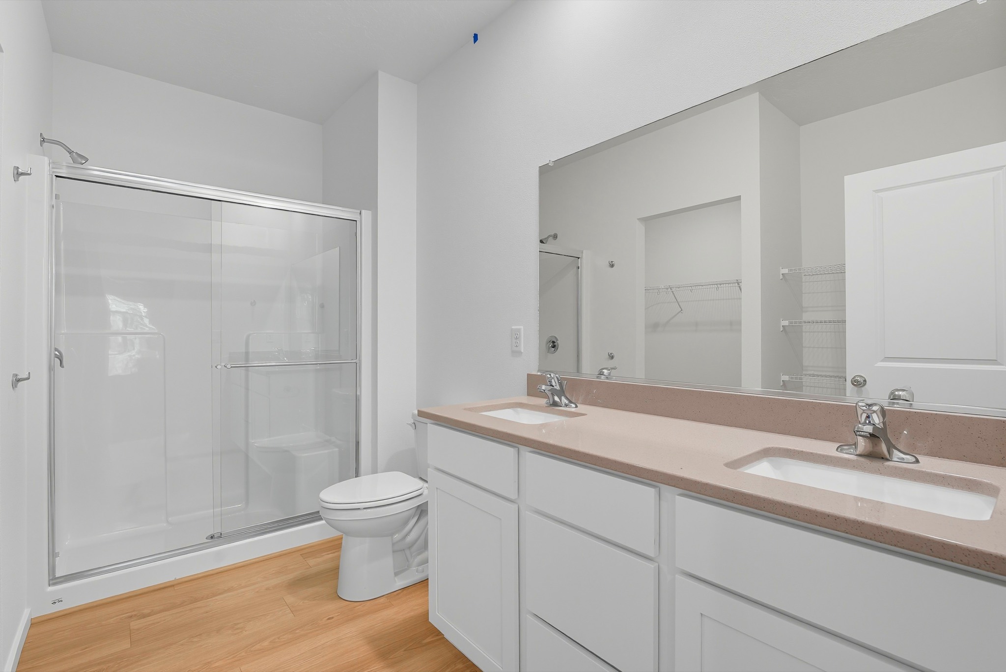The Clark Fork plan: the primary bathroom with a double vanity, a wide framed mirror and a glass-door shower.