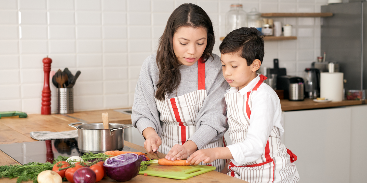Mother and son preparing ingredients for a meal in their kitchen