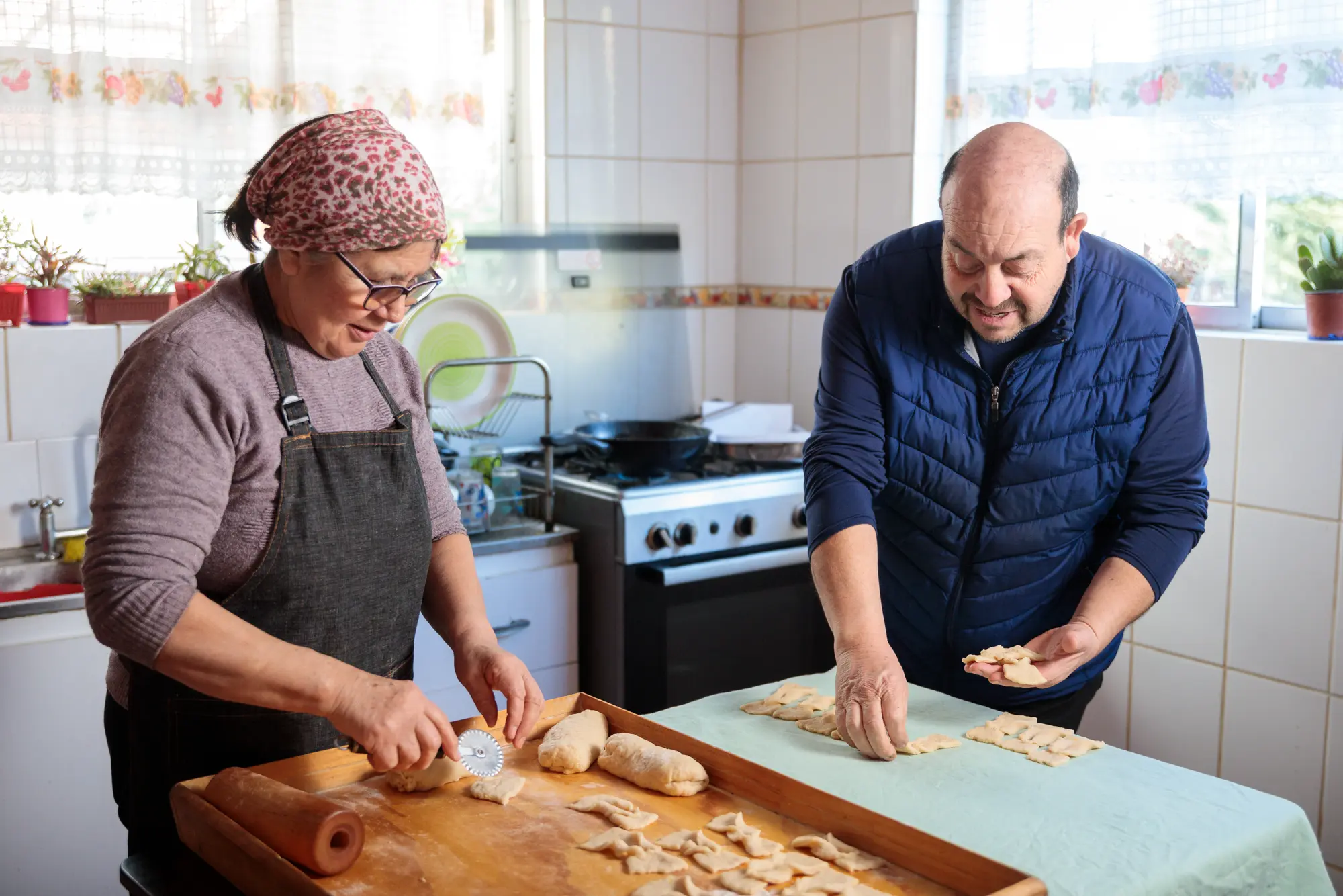Couple making food in kitchen at home.