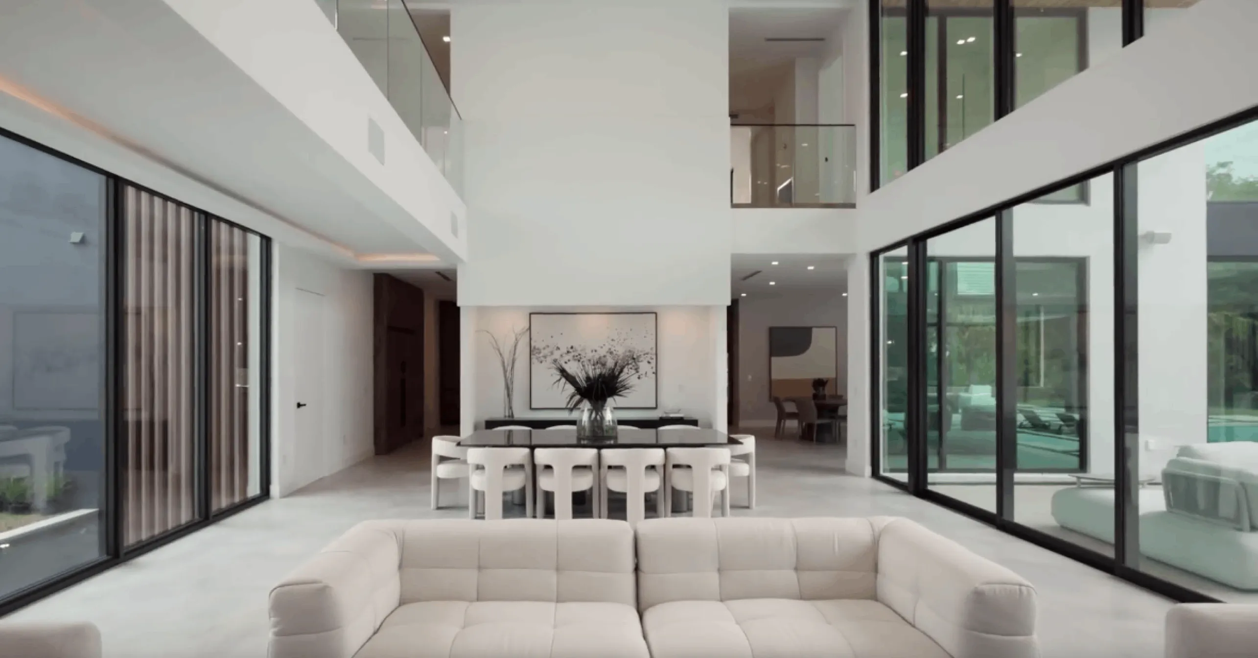 Bright modern dining and living area with glass walls