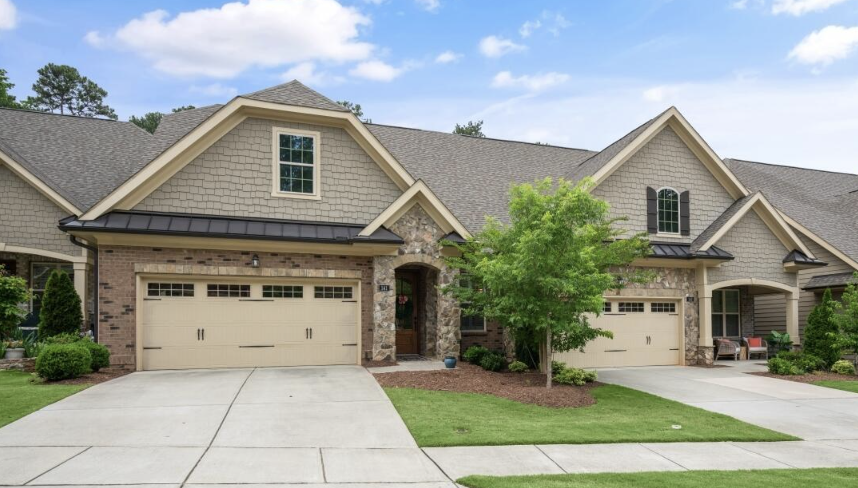 Paired homes with stone accents and front-entry garages