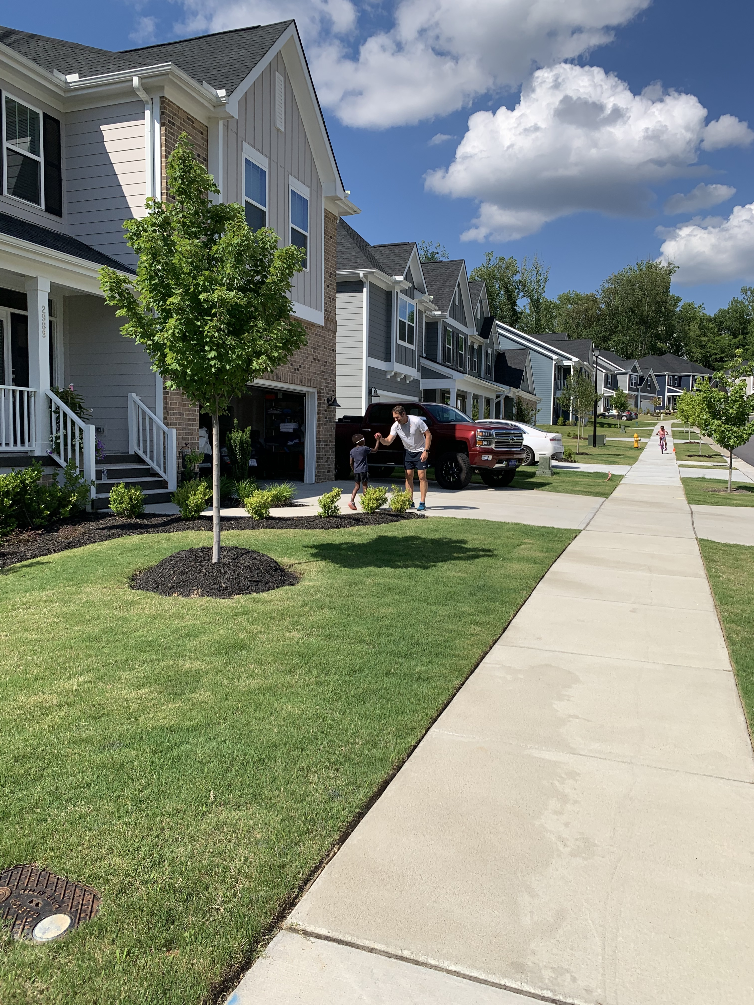 Tree-lined Raleigh-area neighborhood with homes and sidewalks