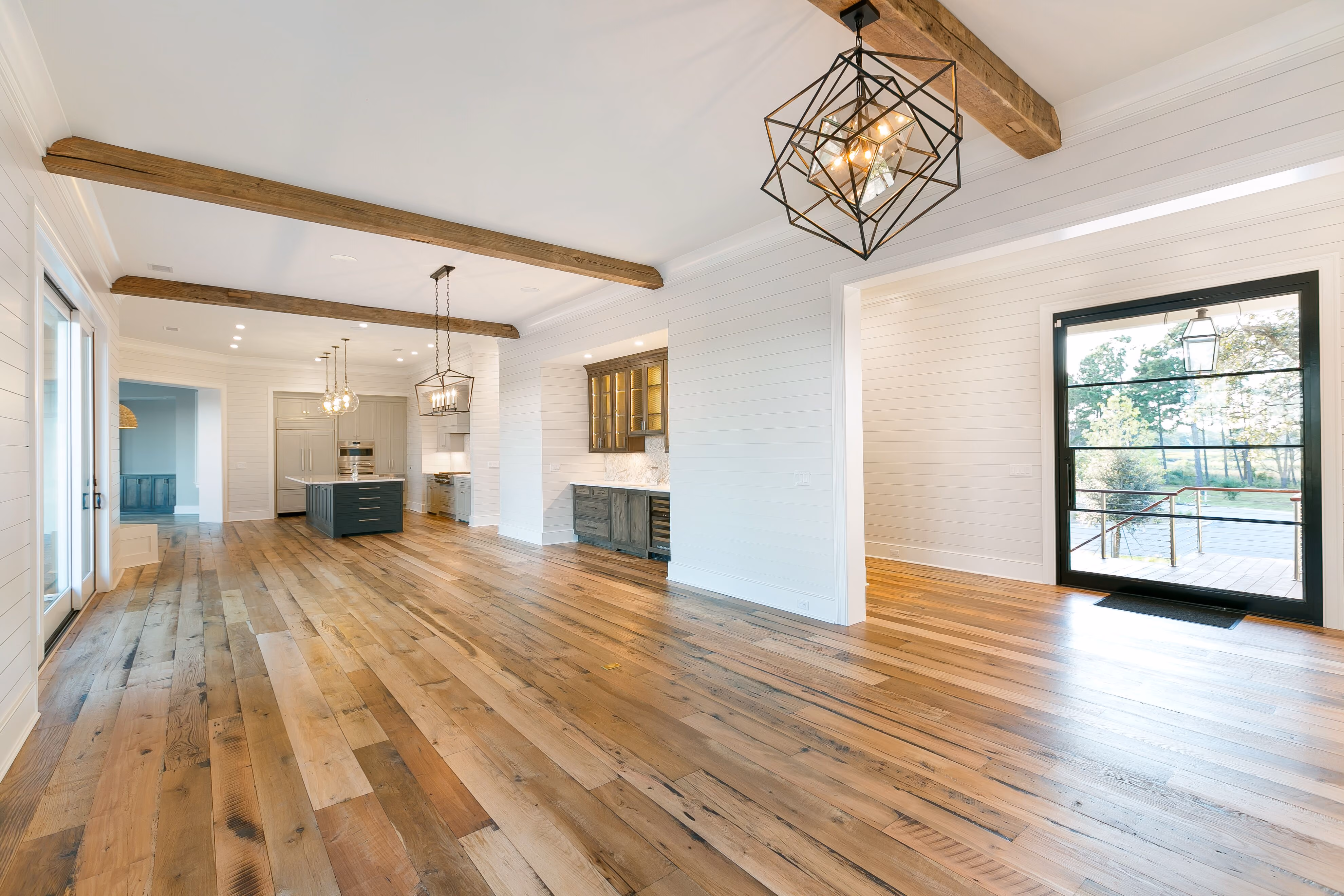 Bright living room with light hardwood flooring and a round area rug