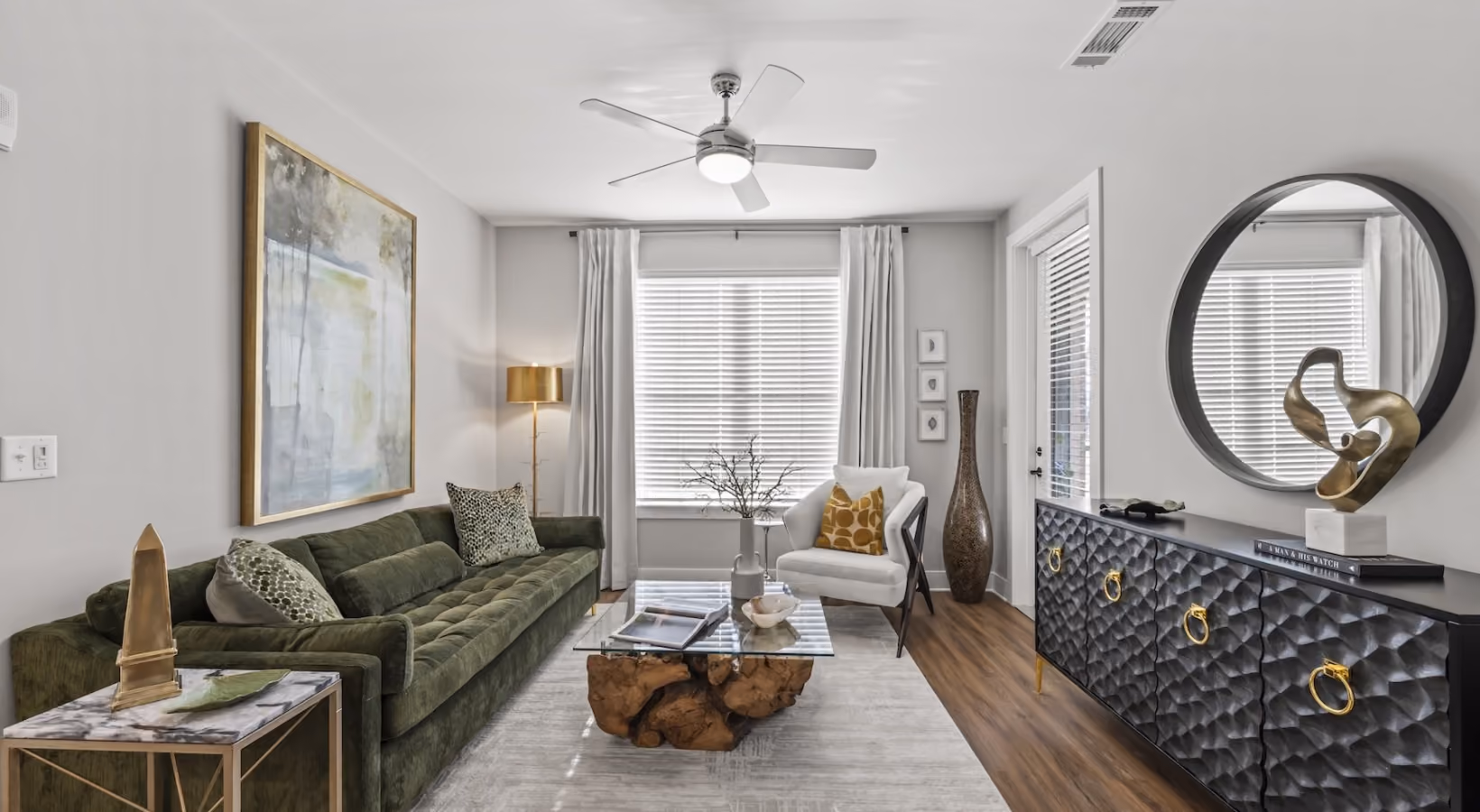 Modern apartment lounge with wood flooring and a sectional sofa
