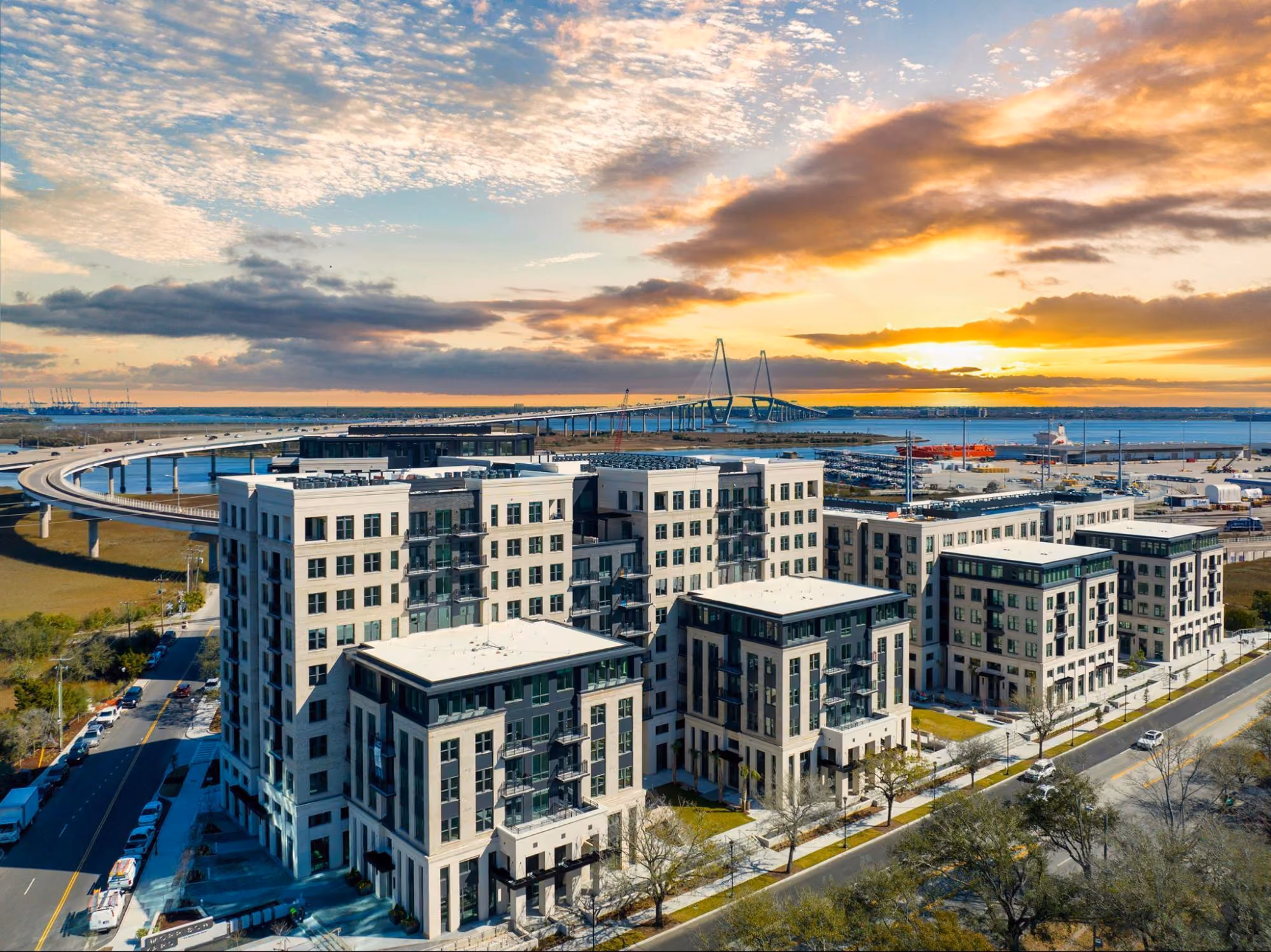Aerial sunset view of a waterfront multi-family housing development in Charleston