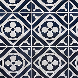 Navy blue and white quatrefoil patterned cement-look tile flooring