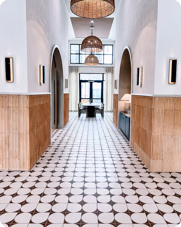 Hallway with white and blue mosaic tile flooring and arched doorways