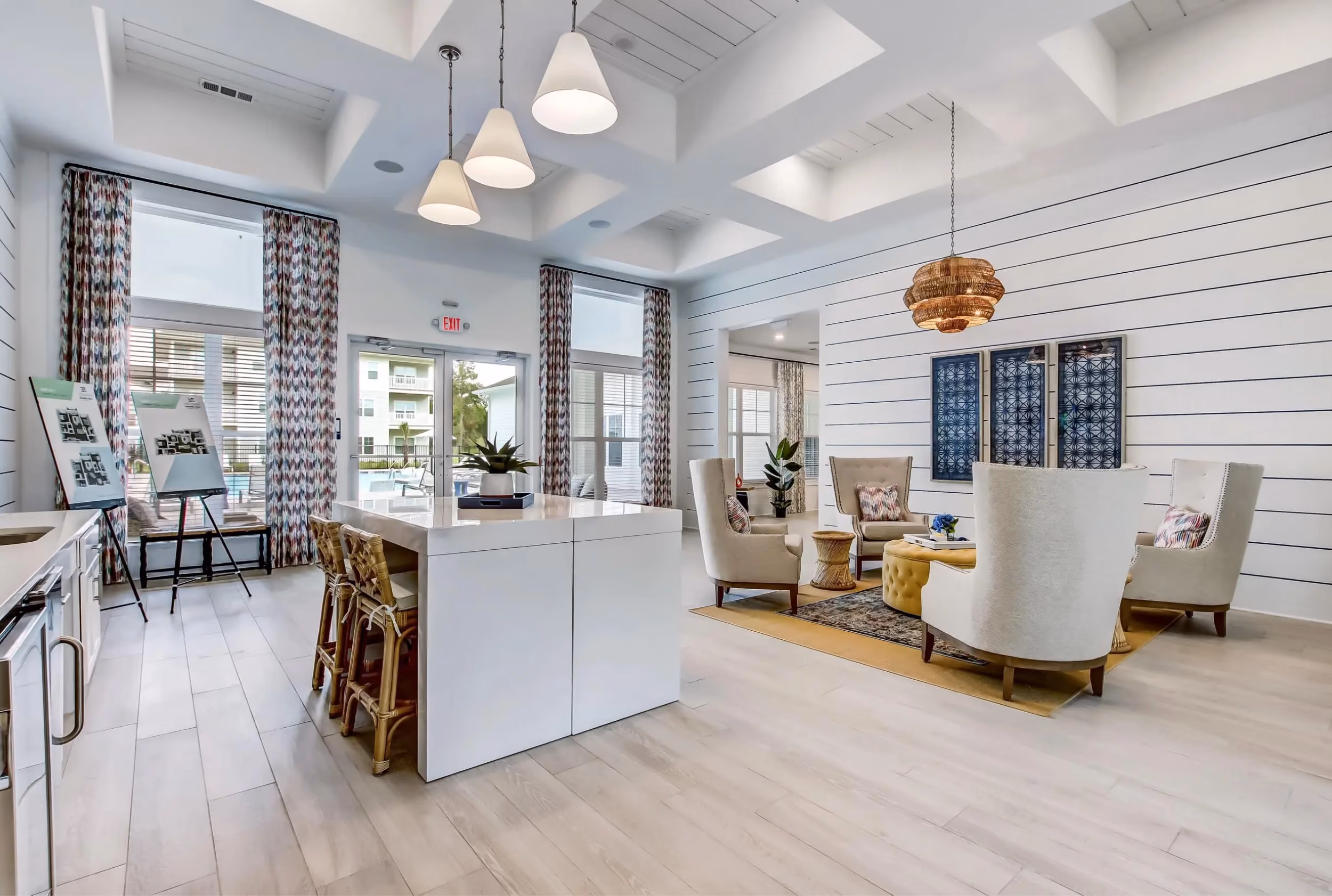 Open-concept community lounge and kitchen with wood-look vinyl plank flooring