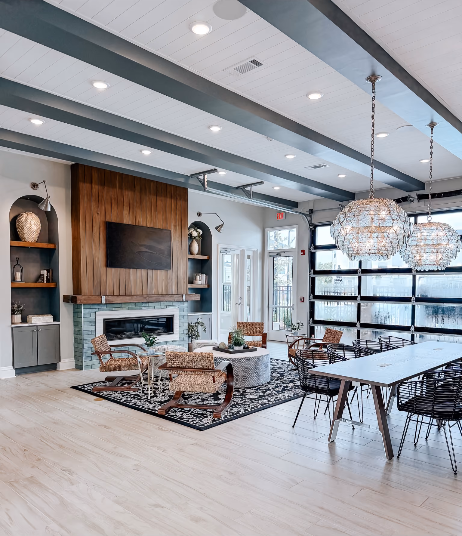 Apartment clubhouse lounge with a fireplace and wood-look vinyl plank flooring
