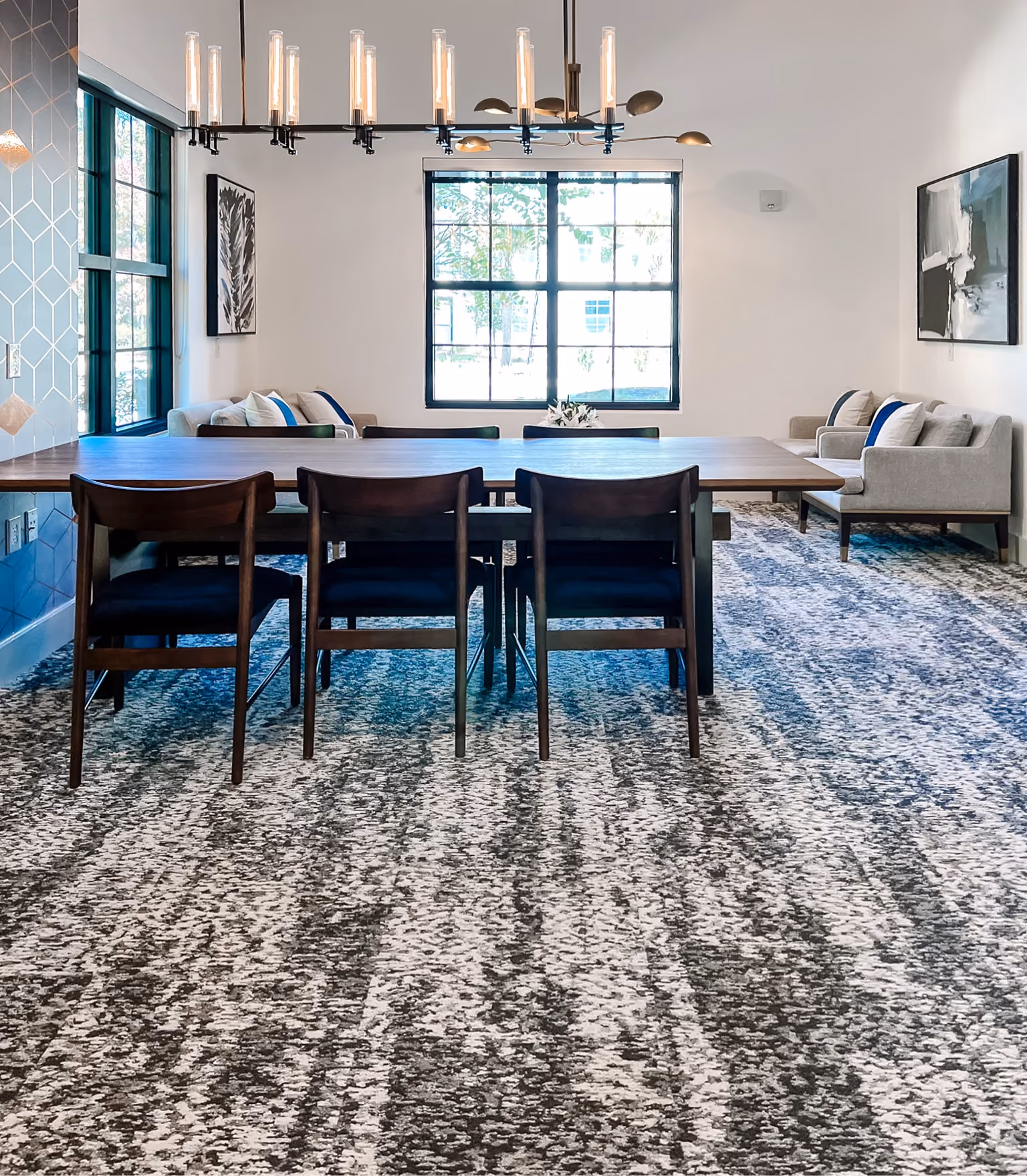 Dining room with patterned blue and gray commercial carpet