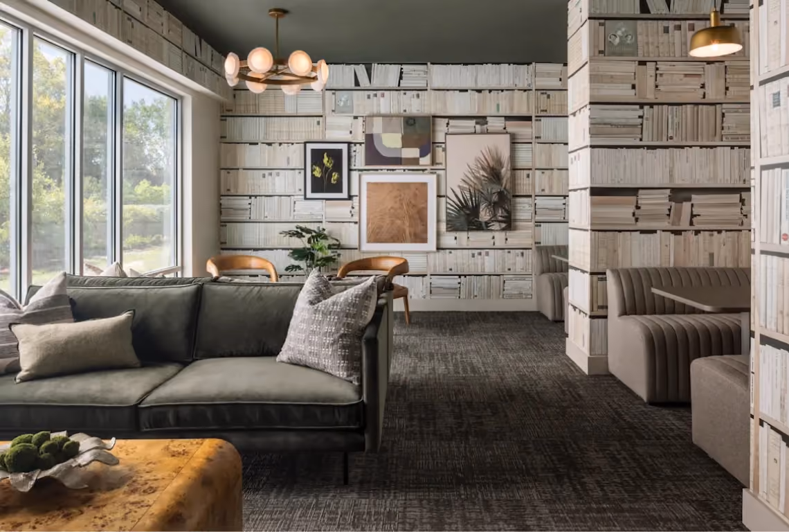 Common area with dark gray carpet and a wood accent wall