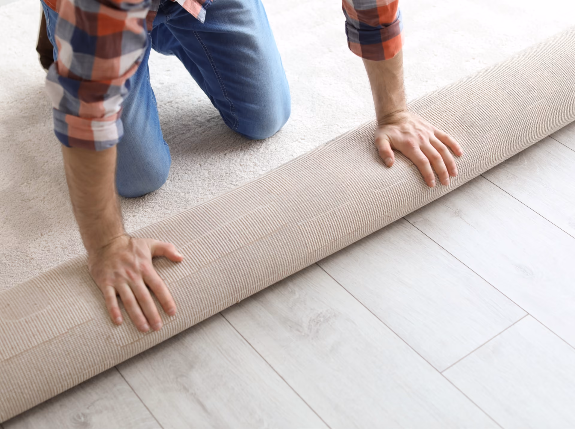 Installer rolling out new carpet flooring