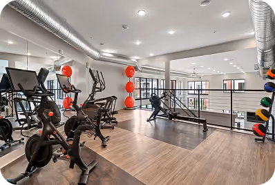 Gym floor with spin bikes and decorative accents on dark sport flooring