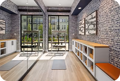 Gym mezzanine with spin bikes and an elliptical on wood-look sport flooring