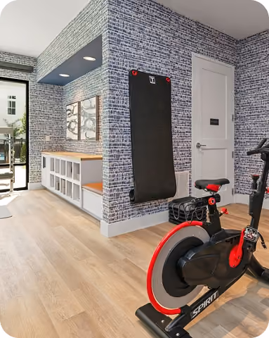Gym nook with a spin bike on gray rubber sport flooring