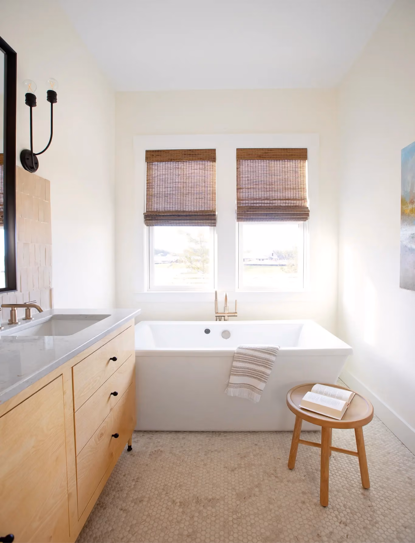 Bathroom with a soaking tub and white tile flooring