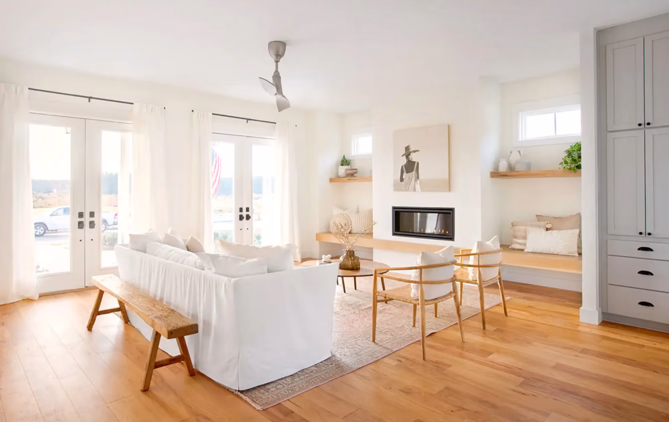 Open-concept living and dining area with wood-look flooring
