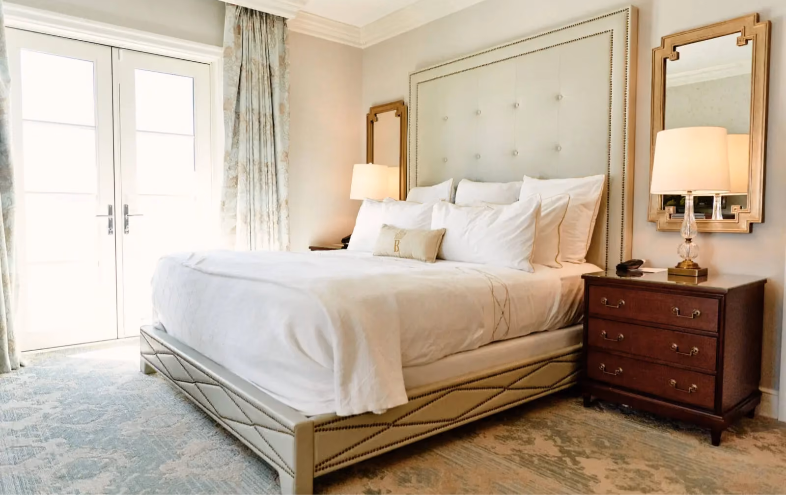 Hotel Bennett guest room with an upholstered bed and patterned carpet flooring