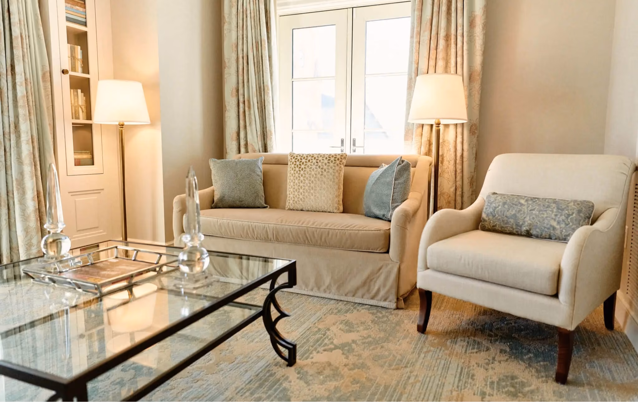 Hotel Bennett guest room seating area with armchairs on patterned carpet