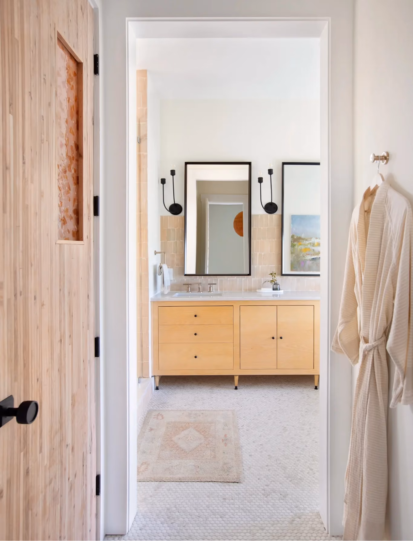 Bathroom vanity with wood cabinetry and white tile flooring