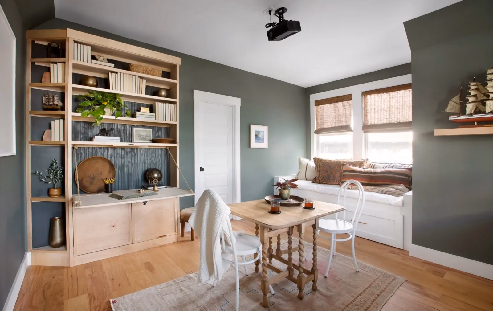 Kitchen nook with built-in shelving and wood-look flooring
