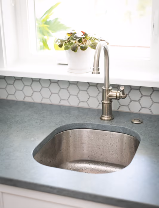 Bathroom vanity with gray hexagon tile flooring