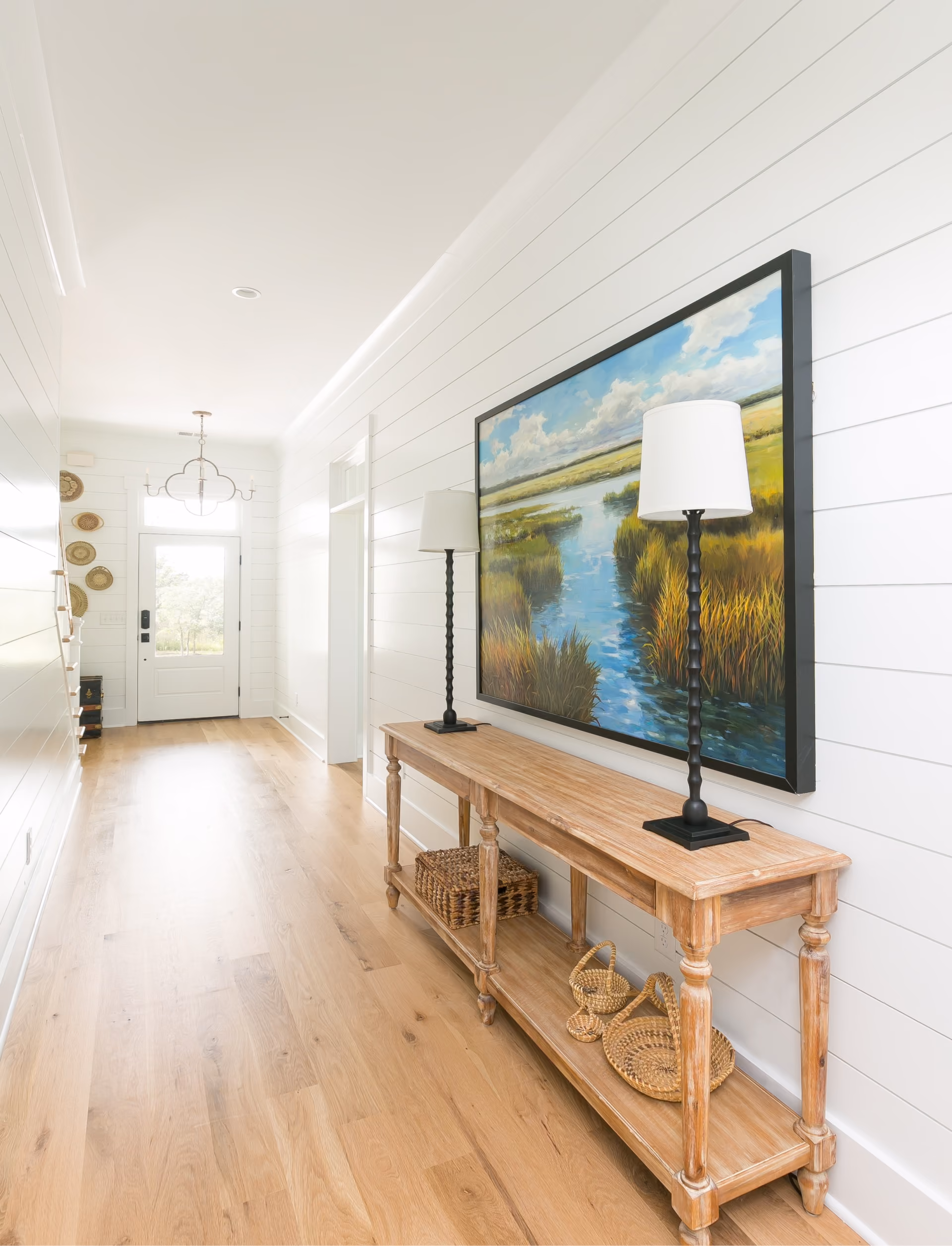 Hallway with a console table and hardwood flooring