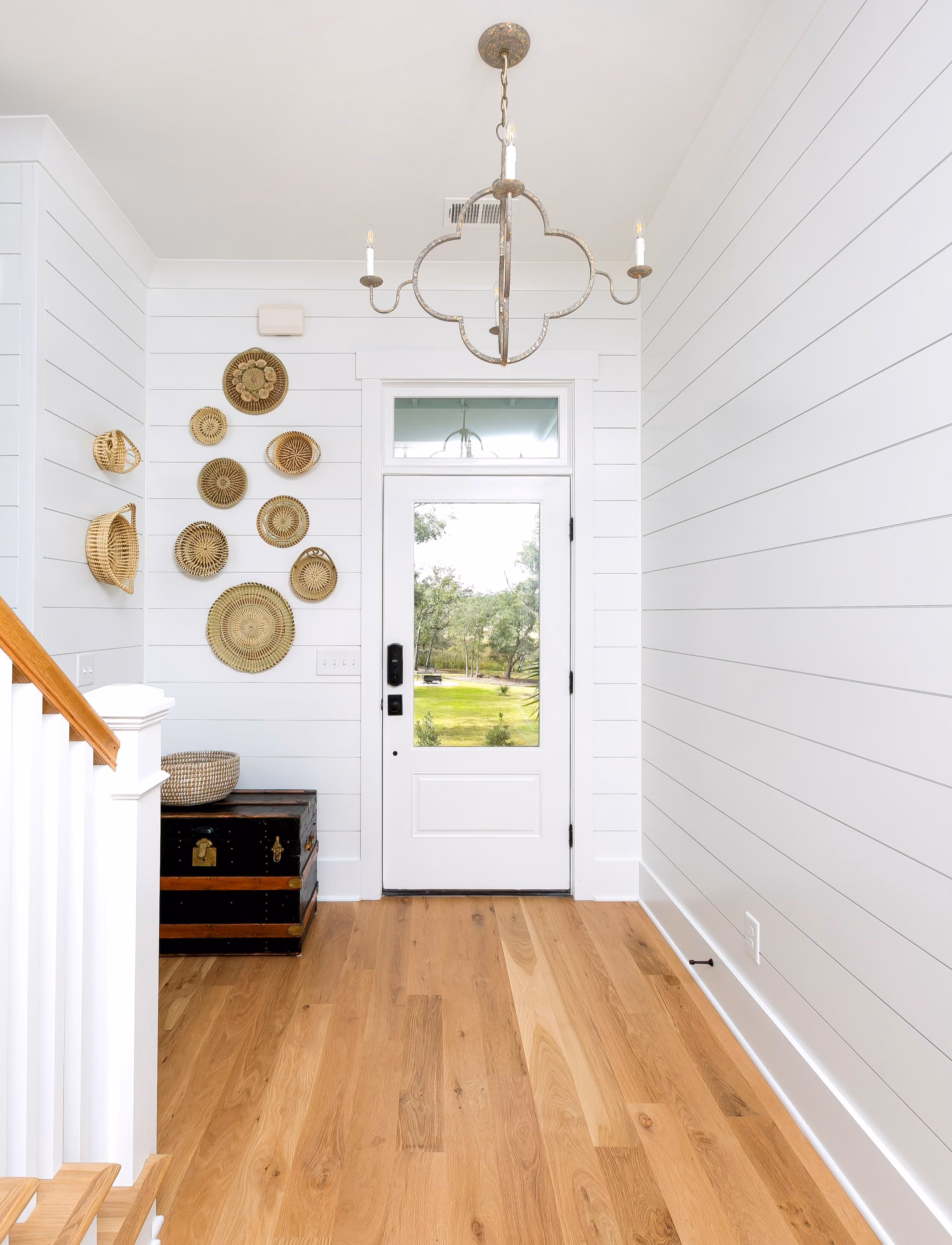 Foyer with decorative wall art and hardwood flooring