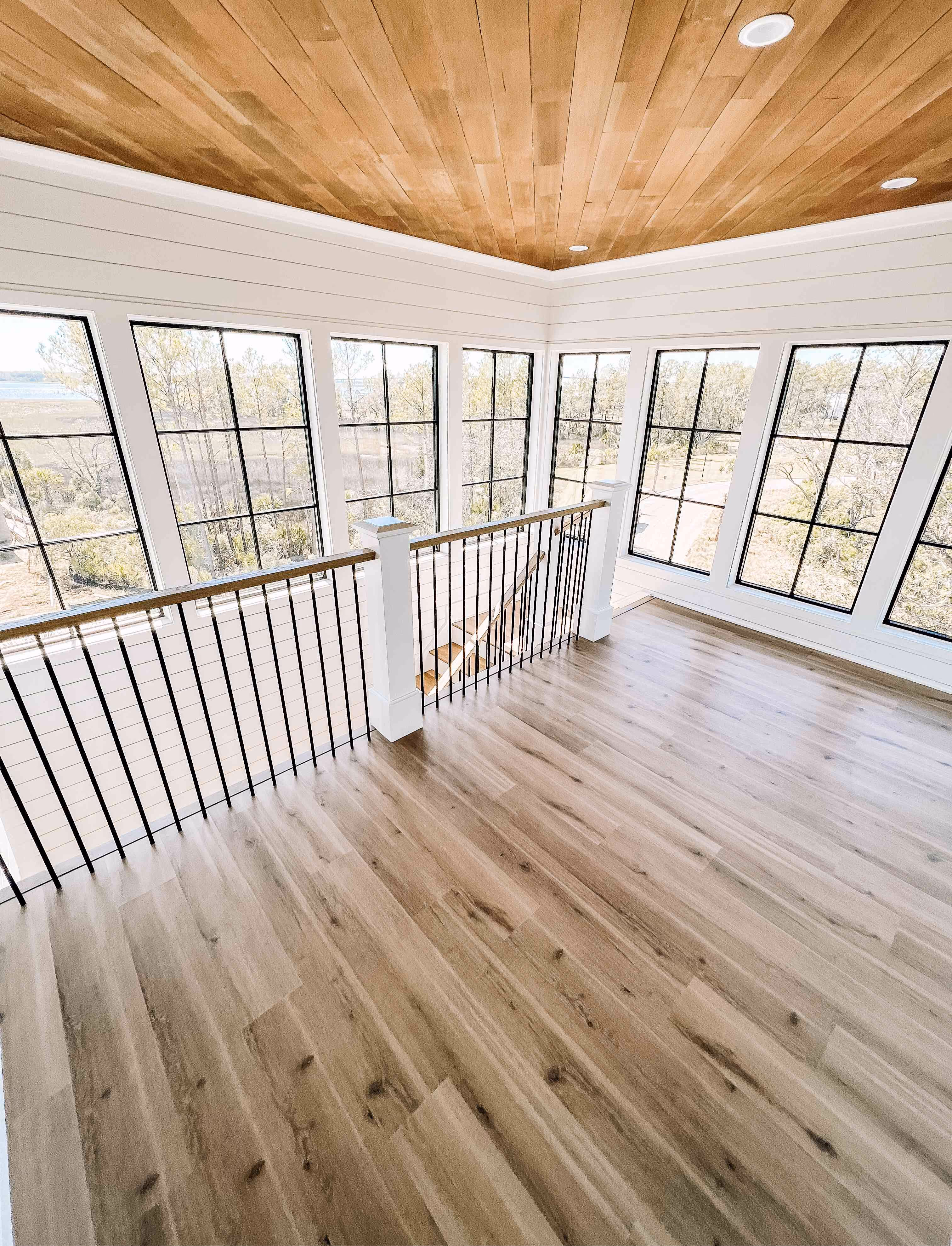 Loft hallway with cable railing and hardwood flooring