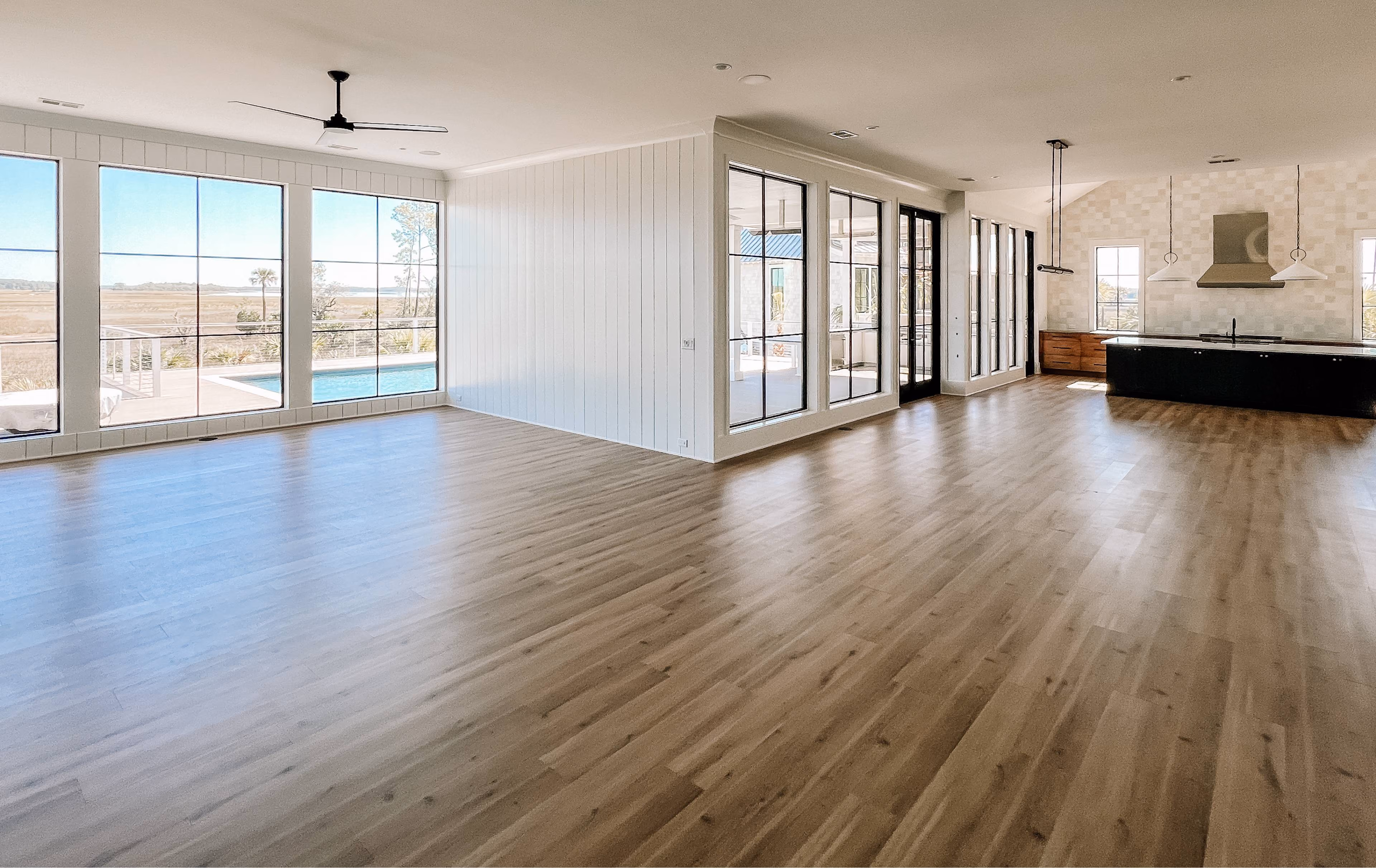 Open-concept living area with wide-plank hardwood flooring and sliding glass doors