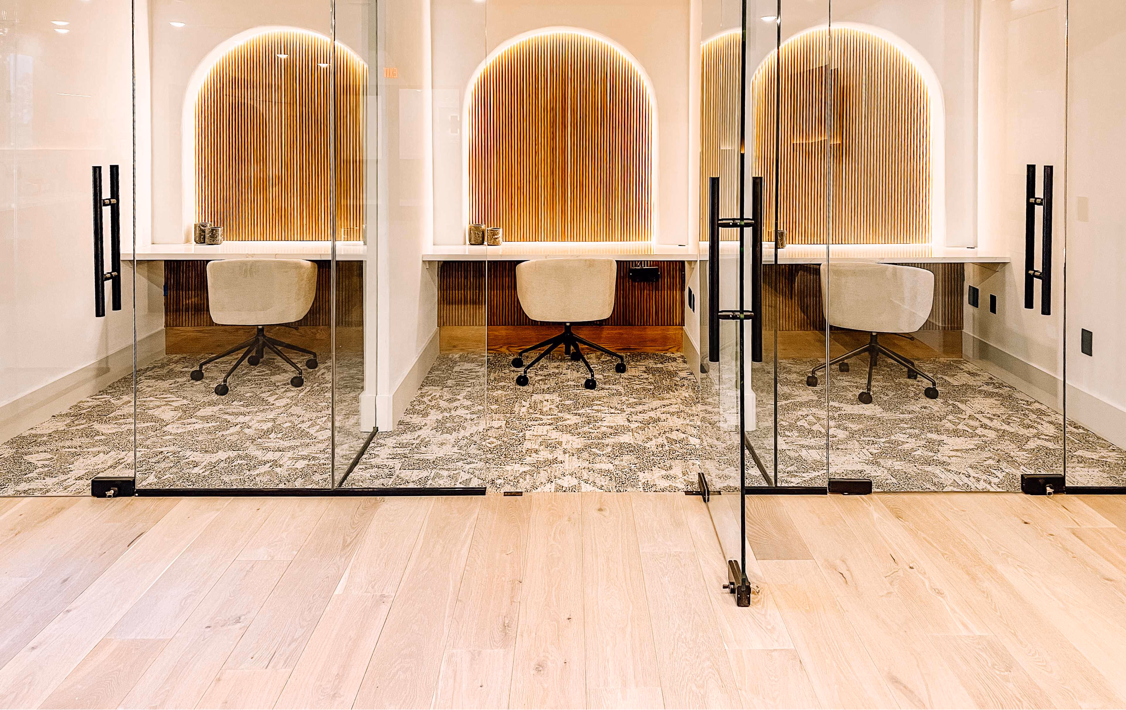 Salon styling stations with mirrors on wood-look flooring